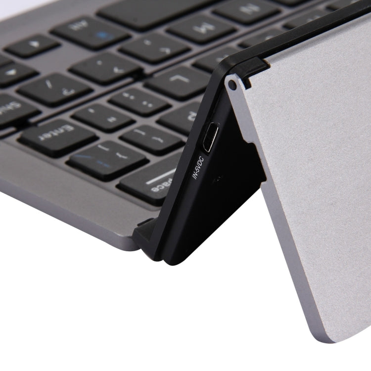 F18 Ultra-slim Rechargeable Foldable 58 Keys Bluetooth Wireless Keyboard with Holder — view 7